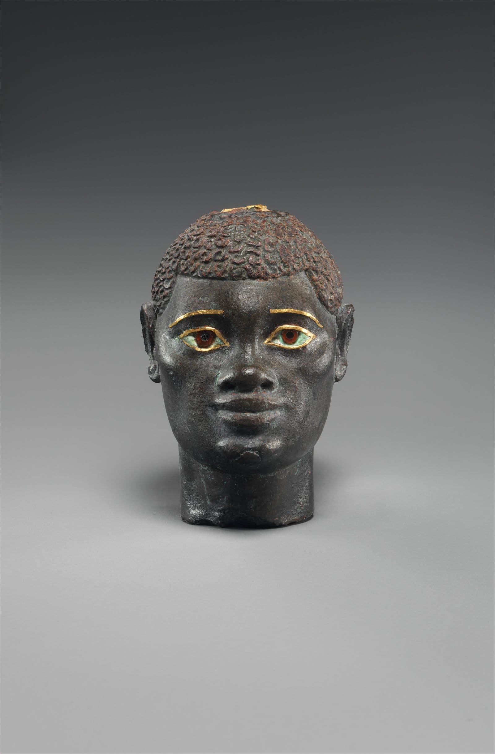Carved head of an African man rendered in Hellenistic style, from Ptolemaic Egypt.